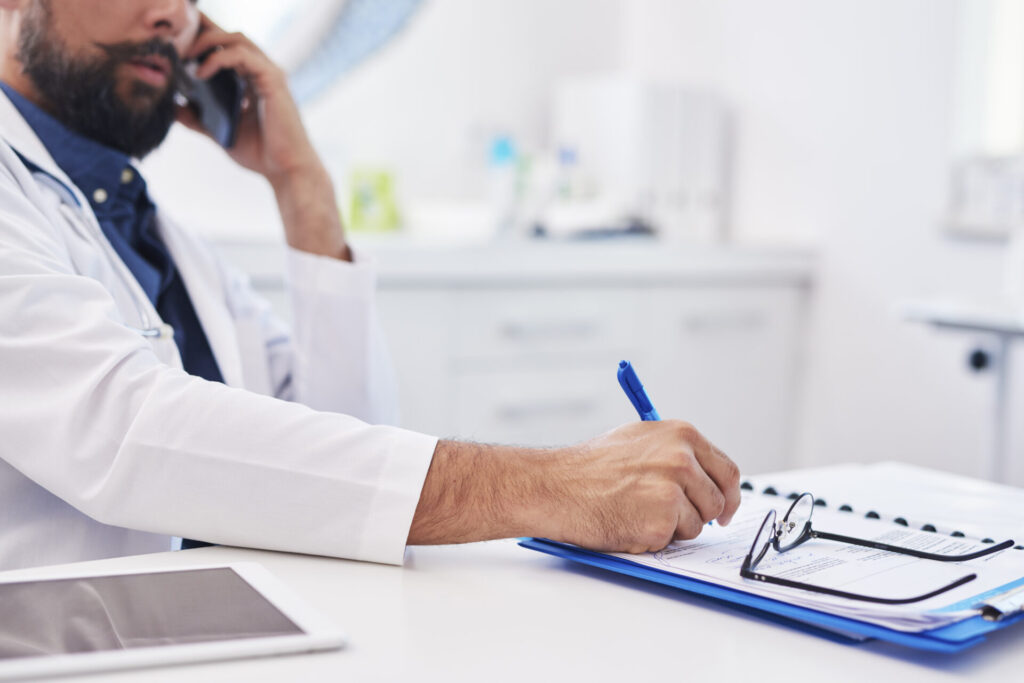 The accident doctor is talking on the phone